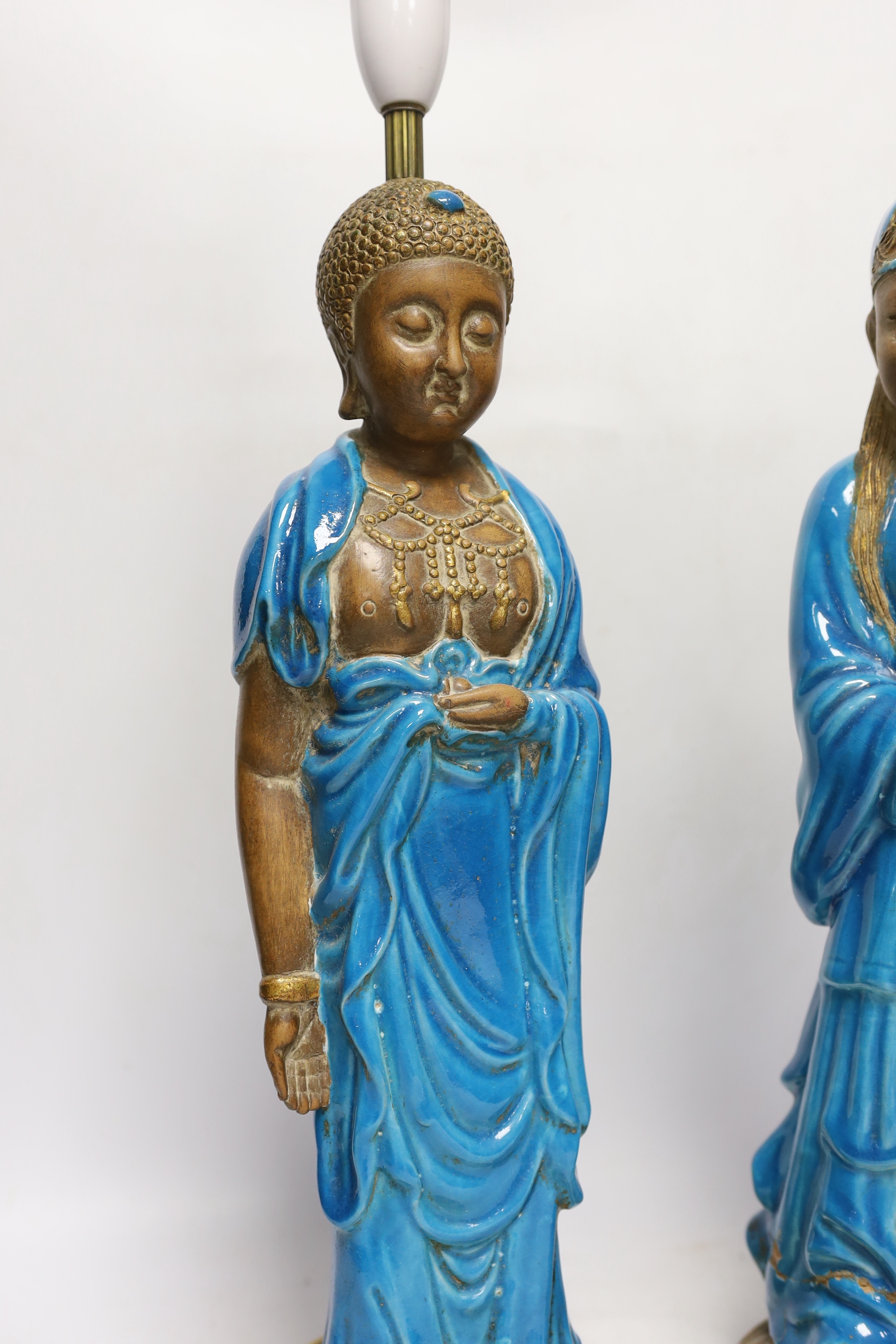 Two Chinese decoratively glazed and gilded pottery figures converted to lamp bases, approximately 44cm high